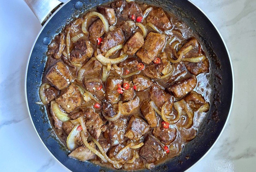 Ox liver is a savory West African delicacy, slow-cooked with onions and chili.